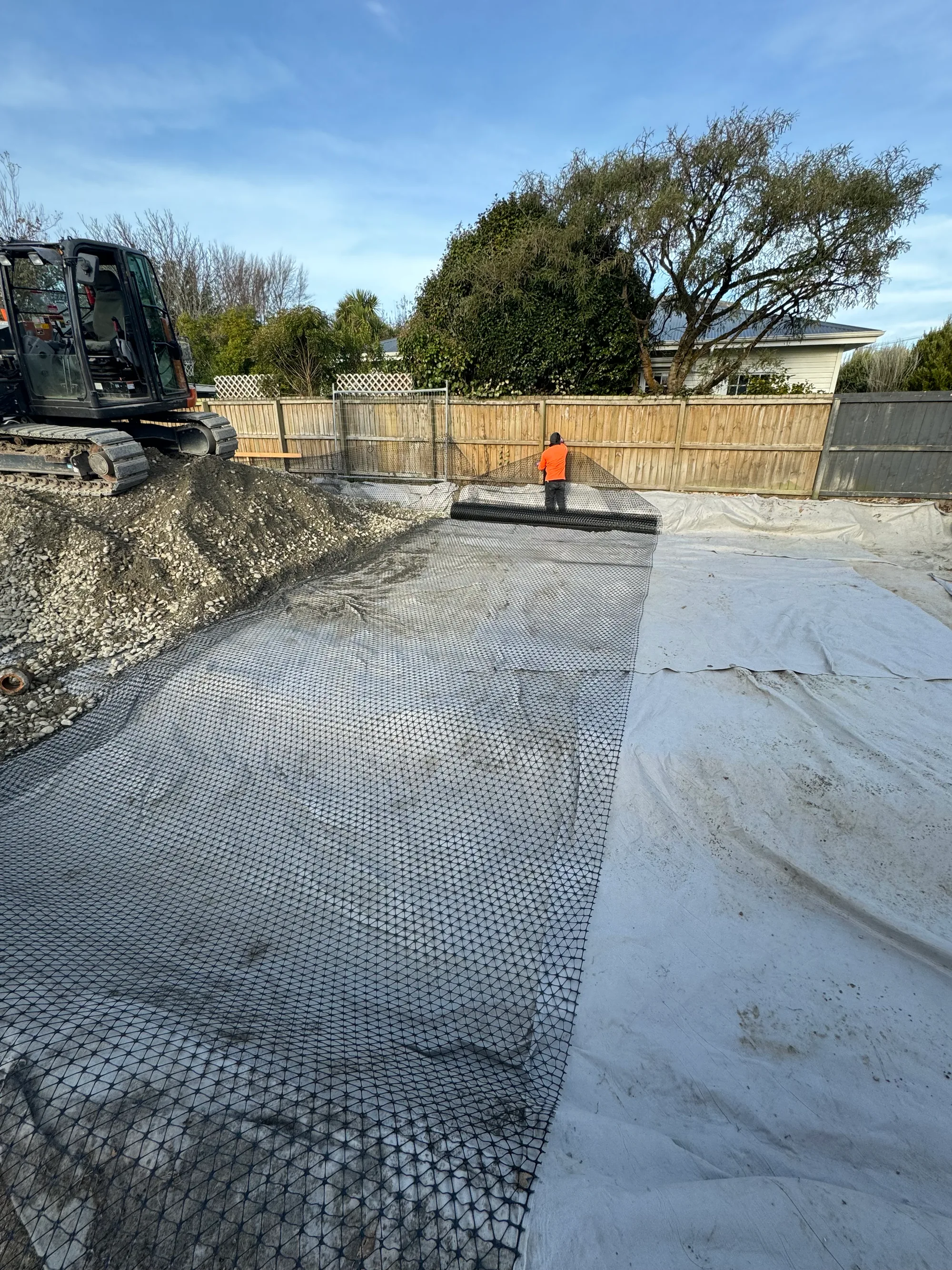 Mini excavator and operator on Canterbury residential site